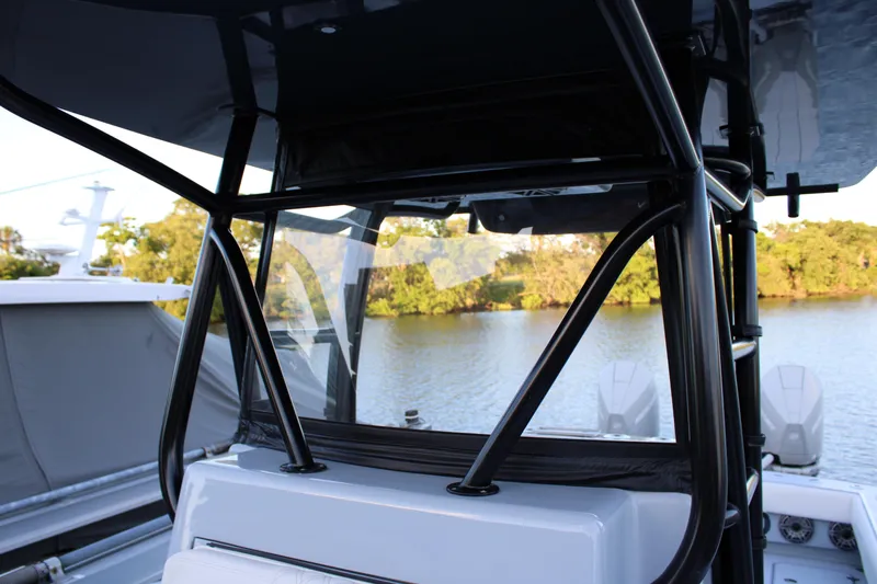  Yacht Photos Pics 2019 Conch 33 boat with sleek black frame, docked by a serene lake.