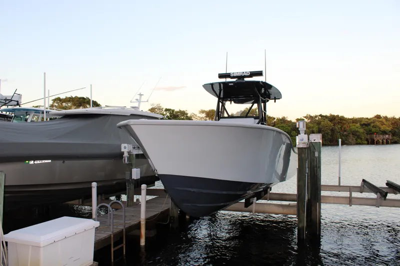  Yacht Photos Pics 2019 Conch 33 boat docked on a lift by the water.