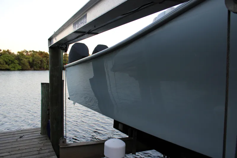  Yacht Photos Pics 2019 Conch 33 boat on lift by waterfront dock.