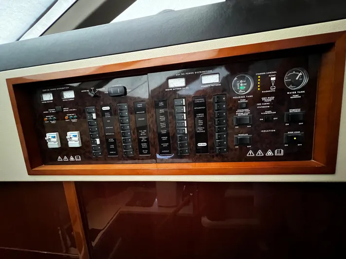  Yacht Photos Pics Control panel of a 2008 Princess 50 yacht, featuring various switches and gauges.