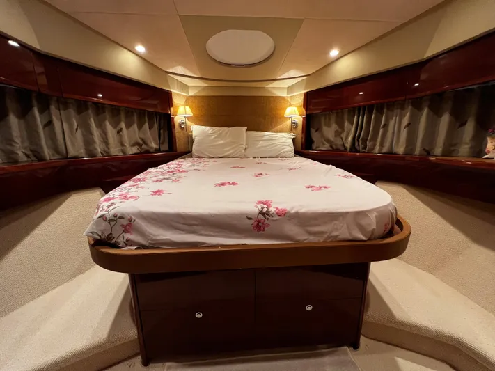  Yacht Photos Pics Luxurious bedroom interior of 2008 Princess 50 yacht with elegant bedding and ambient lighting.