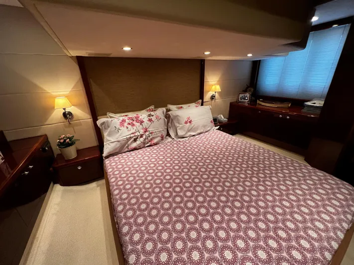  Yacht Photos Pics Luxurious bedroom interior of a 2008 Princess 50 yacht with elegant bedding and ambient lighting.