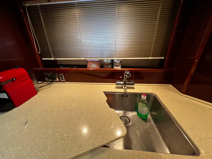  Yacht Photos Pics Kitchen sink area in a 2008 Princess 50 yacht with countertop and blinds.