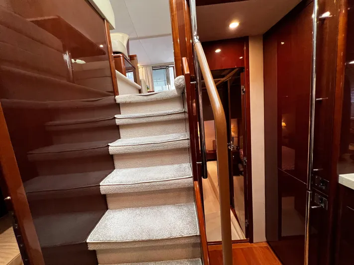  Yacht Photos Pics Luxurious interior of 2008 Princess 50 yacht with carpeted stairs and polished wood finishes.