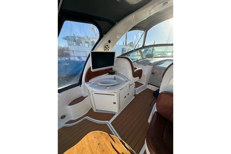  Yacht Photos Pics Interior of 2006 Sea Ray 340 Sundancer yacht with seating and a mounted TV.