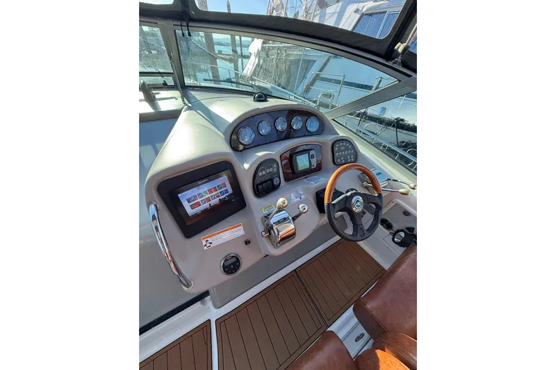  Yacht Photos Pics 2006 Sea Ray 340 Sundancer helm with modern controls and wood-accented steering wheel.