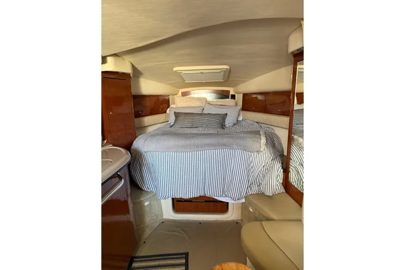  Yacht Photos Pics Interior cabin of 2006 Sea Ray 340 Sundancer with cozy bed and striped bedding.