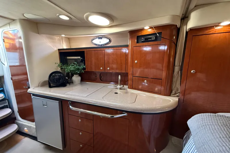  Yacht Photos Pics 2006 Sea Ray 340 Sundancer interior with elegant wood cabinetry and compact kitchenette.