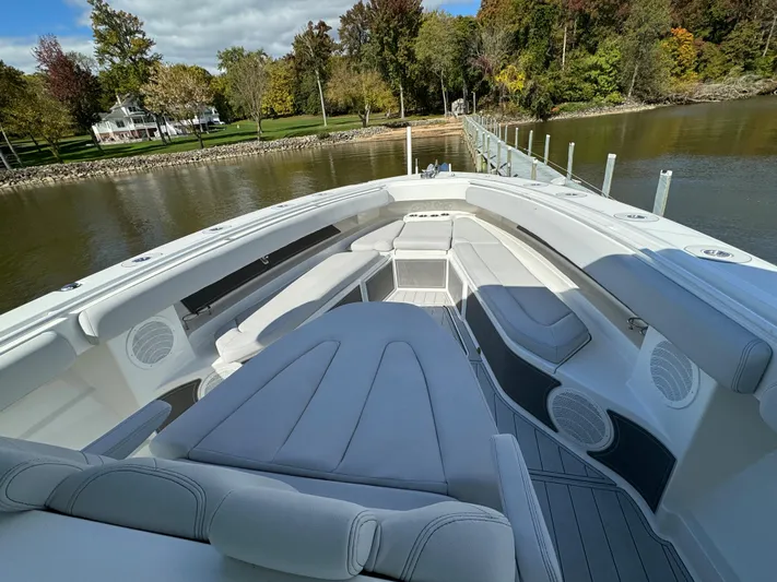  Yacht Photos Pics 2019 HCB Siesta boat with luxurious seating, docked by a scenic riverside.