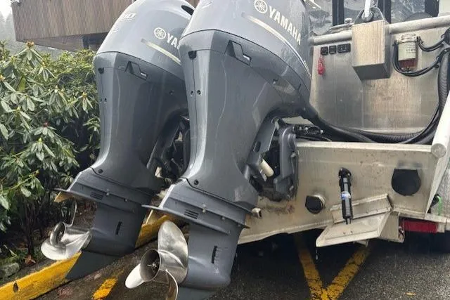 Uno Yacht Photos Pics Twin Yamaha outboard motors on a 2012 Jaxoncraft Custom Hardtop boat, parked outdoors.