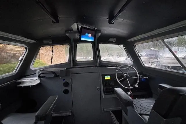 Uno Yacht Photos Pics Interior of 2012 Jaxoncraft Custom Hardtop boat with steering wheel and navigation screen.