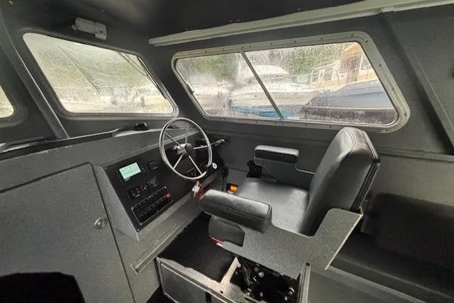 Uno Yacht Photos Pics Interior of a 2012 Jaxoncraft Custom Hardtop boat with steering wheel and control panel.