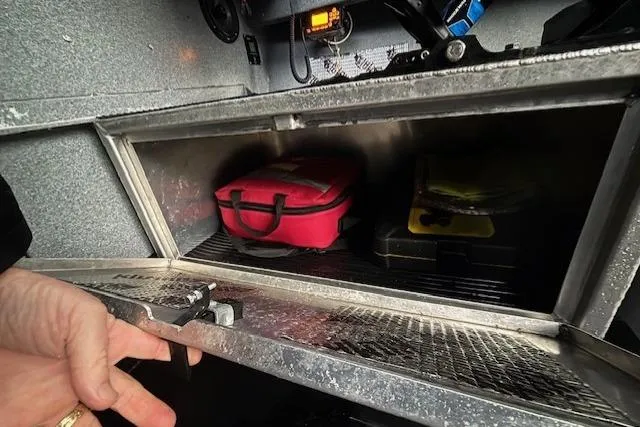 Uno Yacht Photos Pics Storage compartment in a 2012 Jaxoncraft Custom Hardtop with red and black cases.