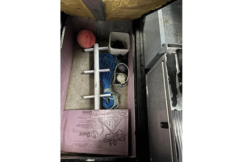 Uno Yacht Photos Pics Storage compartment with various items in a 2012 Jaxoncraft Custom Hardtop boat.