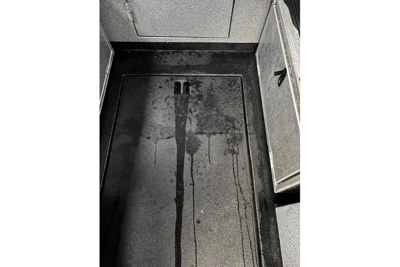 Uno Yacht Photos Pics Wet floor inside 2012 Jaxoncraft Custom Hardtop boat, showing water stains and storage compartments.