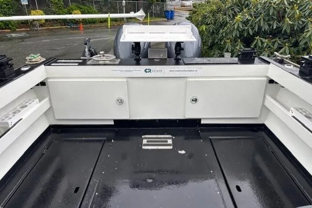 Uno Yacht Photos Pics 2012 Jaxoncraft Custom Hardtop boat interior with storage compartments and sleek black flooring.