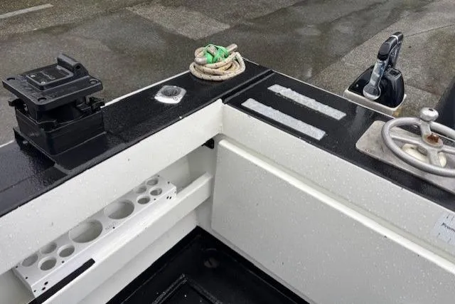 Uno Yacht Photos Pics 2012 Jaxoncraft Custom Hardtop boat interior with equipment and rope on a wet deck.