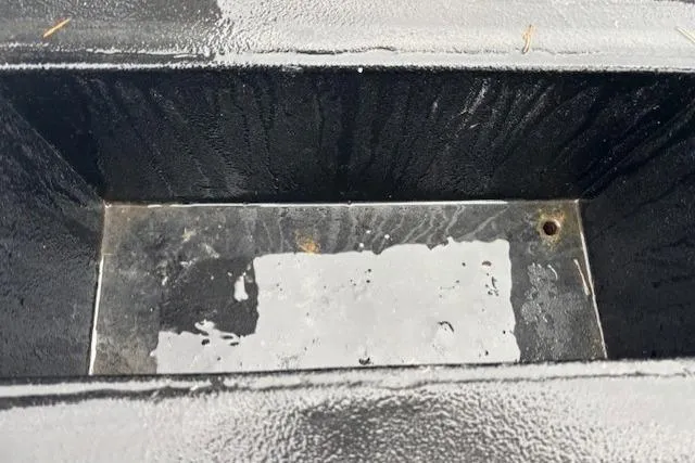 Uno Yacht Photos Pics Black metal compartment of 2012 Jaxoncraft Custom Hardtop, showing water accumulation.