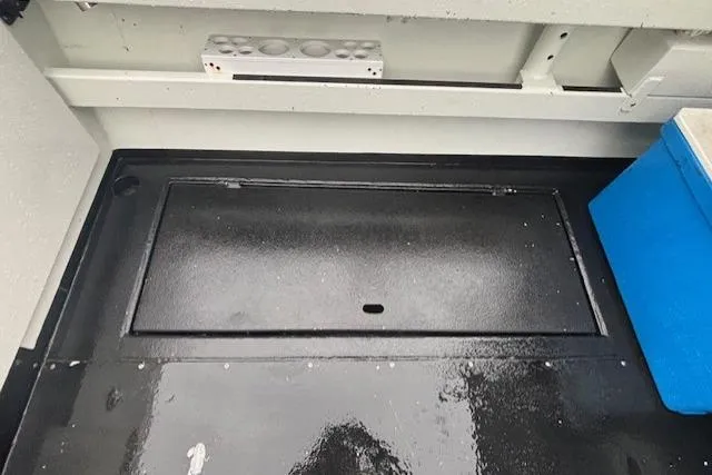 Uno Yacht Photos Pics 2012 Jaxoncraft Custom Hardtop interior with storage compartment and blue cooler.