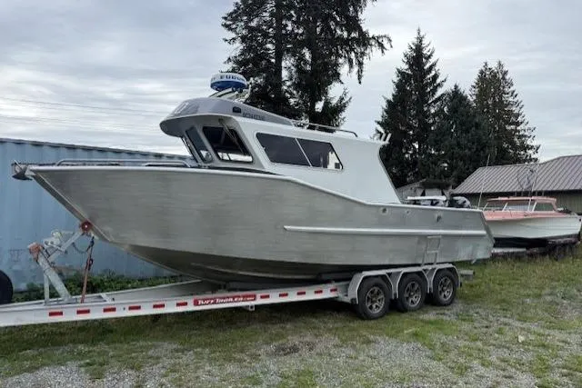 Uno Yacht Photos Pics 2012 Jaxoncraft Custom Hardtop boat on trailer, parked outdoors near trees and buildings.