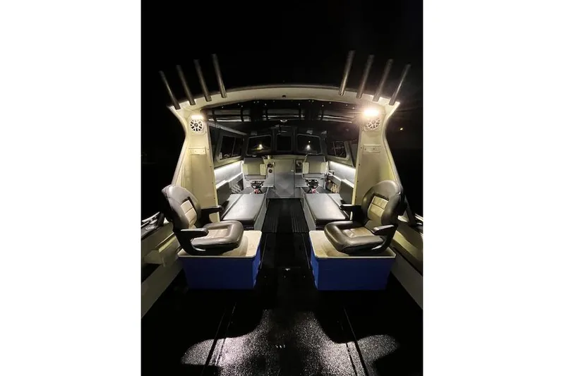 Uno Yacht Photos Pics Interior of 2012 Jaxoncraft Custom Hardtop boat, featuring seating and illuminated dashboard at night.