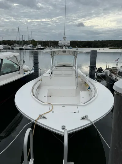  Yacht Photos Pics 2009 Regulator 34SS boat docked in a marina under cloudy skies.