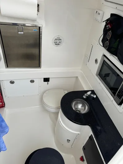  Yacht Photos Pics 2009 Regulator 34SS boat interior with sink, toilet, and storage compartments.