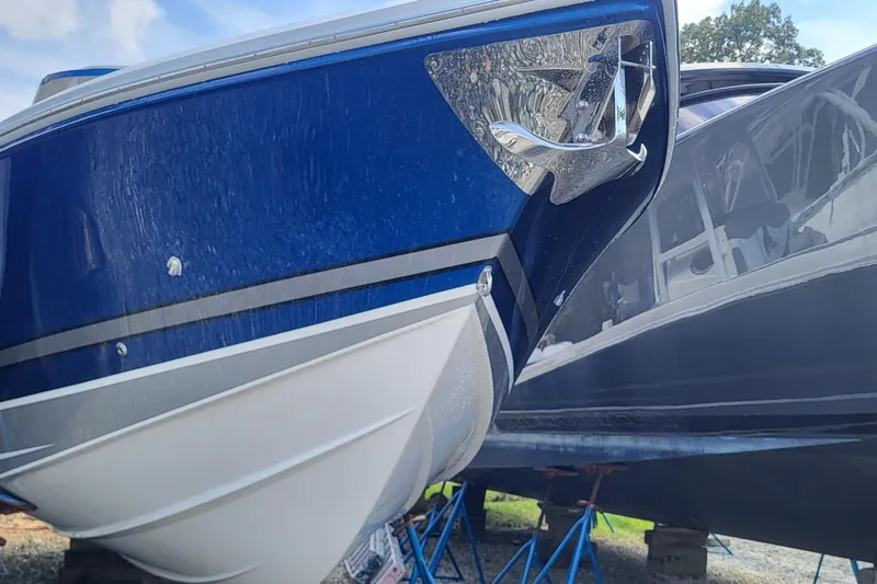  Yacht Photos Pics 2022 Fountain 34 SC boat with sleek blue and white hull design.