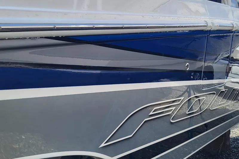  Yacht Photos Pics Side view of a 2022 Fountain 34 SC boat with sleek blue and gray design.