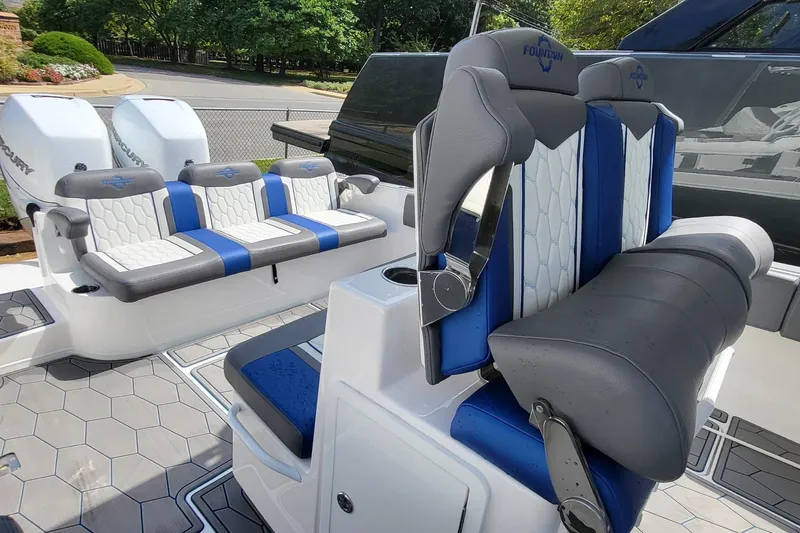  Yacht Photos Pics 2022 Fountain 34 SC boat interior with blue and gray seating, featuring Mercury engines.