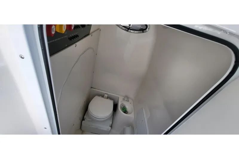  Yacht Photos Pics 2022 Fountain 34 SC boat interior with compact marine toilet.
