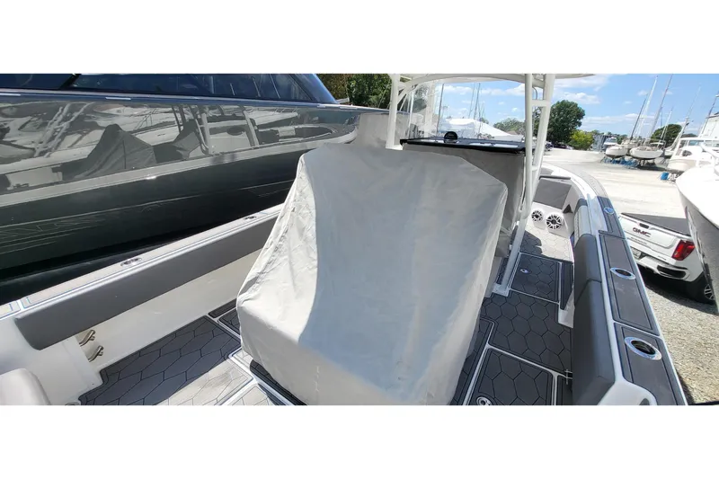  Yacht Photos Pics 2022 Fountain 34 SC boat interior with covered seating and modern design.