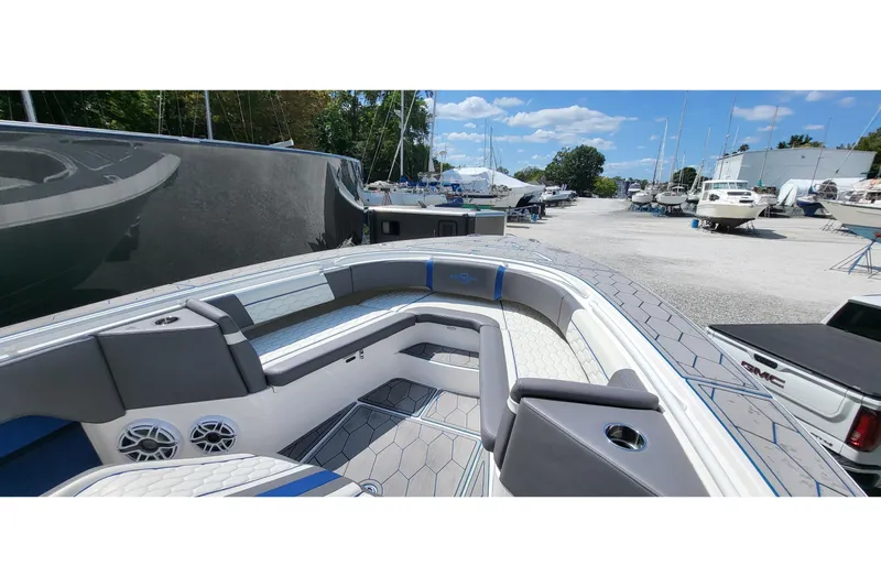  Yacht Photos Pics 2022 Fountain 34 SC boat interior with seating and speakers, docked among other boats.