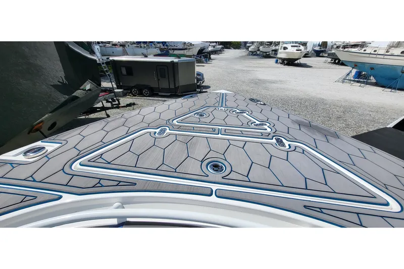  Yacht Photos Pics 2022 Fountain 34 SC boat deck with modern geometric design in a marina setting.