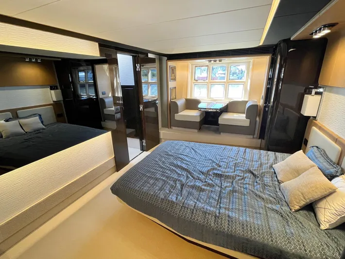  Yacht Photos Pics Luxurious bedroom interior of 2016 Azimut 77S yacht with modern furnishings and large windows.