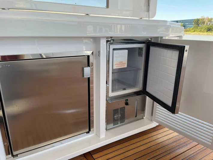  Yacht Photos Pics Open mini fridge on 2016 Azimut 77S yacht with stainless steel finish.