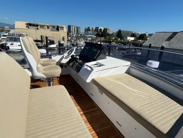  Yacht Photos Pics 2016 Azimut 77S yacht helm with beige seating and modern controls, docked in a marina.