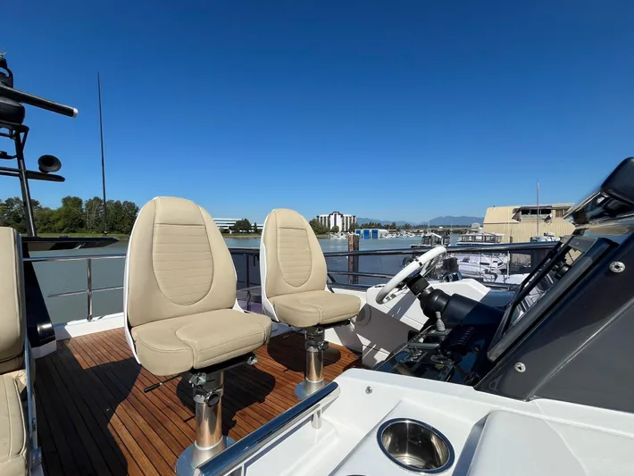  Yacht Photos Pics 2016 Azimut 77S yacht deck with beige seats and scenic waterfront view.