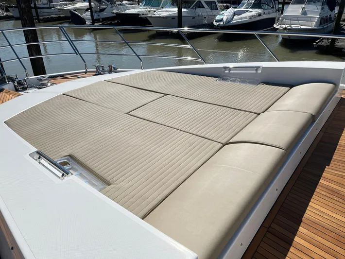  Yacht Photos Pics Luxurious sunbathing deck on a 2016 Azimut 77S yacht, docked at a marina.