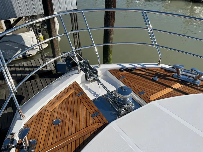  Yacht Photos Pics Bow of 2016 Azimut 77S yacht with teak decking and stainless steel railings.