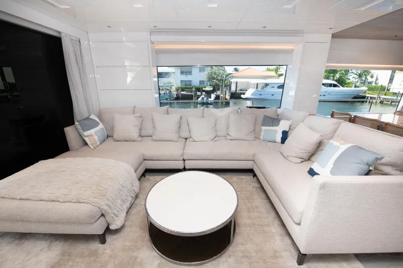 Echo Too - Sl78/753 Yacht Photos Pics Luxurious Sanlorenzo SL78 2022 yacht interior with plush beige sectional sofa and round coffee table.