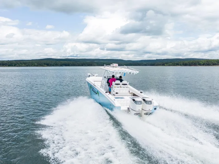 Fantasea Yacht Photos Pics 2019 Fountain 34CC boat cruising on a lake.