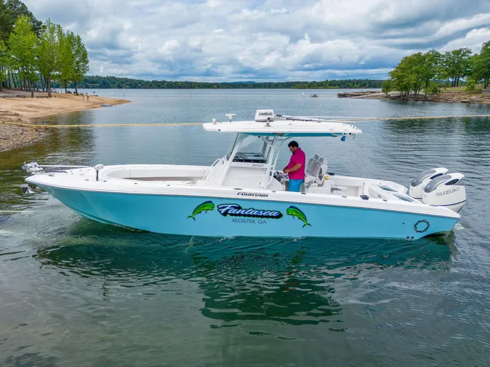 Fantasea Yacht Photos Pics 2019 Fountain 34CC boat on a lake with a person onboard.