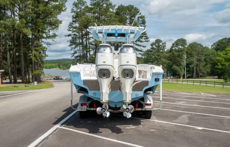 Fantasea Yacht Photos Pics 2019 Fountain 34CC boat with twin outboard engines on a trailer in a parking lot.