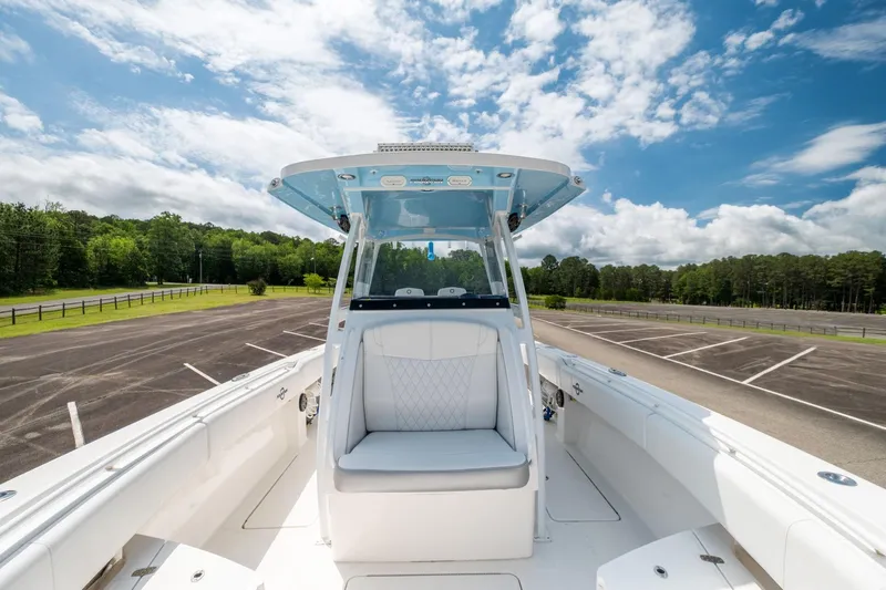 Fantasea Yacht Photos Pics 2019 Fountain 34CC boat with white seating and blue sky background.