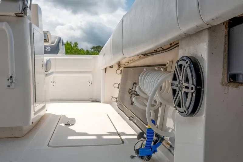 Fantasea Yacht Photos Pics 2019 Fountain 34CC boat interior with coiled hose and speaker.