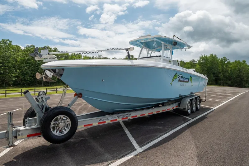 Fantasea Yacht Photos Pics 2019 Fountain 34CC boat on a trailer in a parking lot.