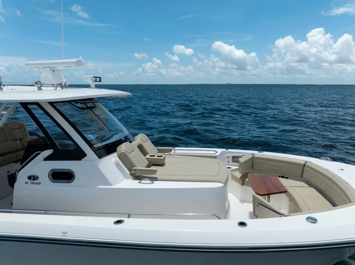 100 Percent Yacht Photos Pics 2018 Pursuit S 368 Sport boat on open water under a clear blue sky.