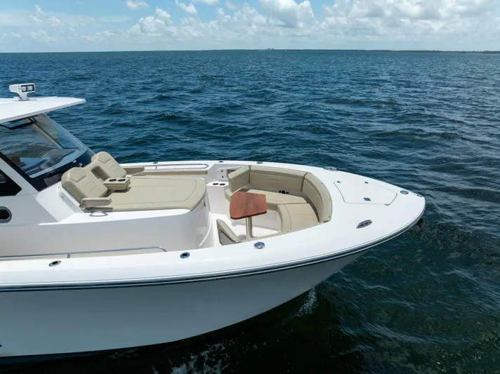 100 Percent Yacht Photos Pics 2018 Pursuit S 368 Sport boat on open water under a clear sky.