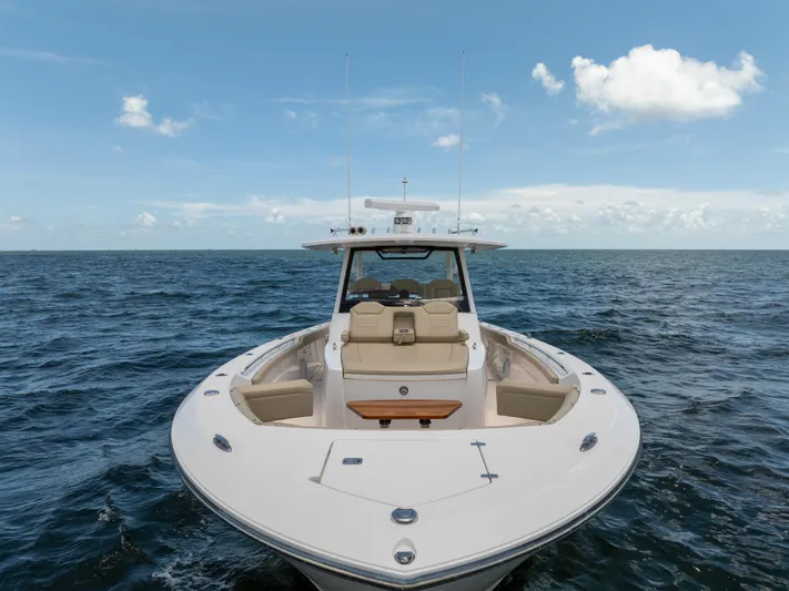 100 Percent Yacht Photos Pics 2018 Pursuit S 368 Sport boat on open sea under clear blue sky.